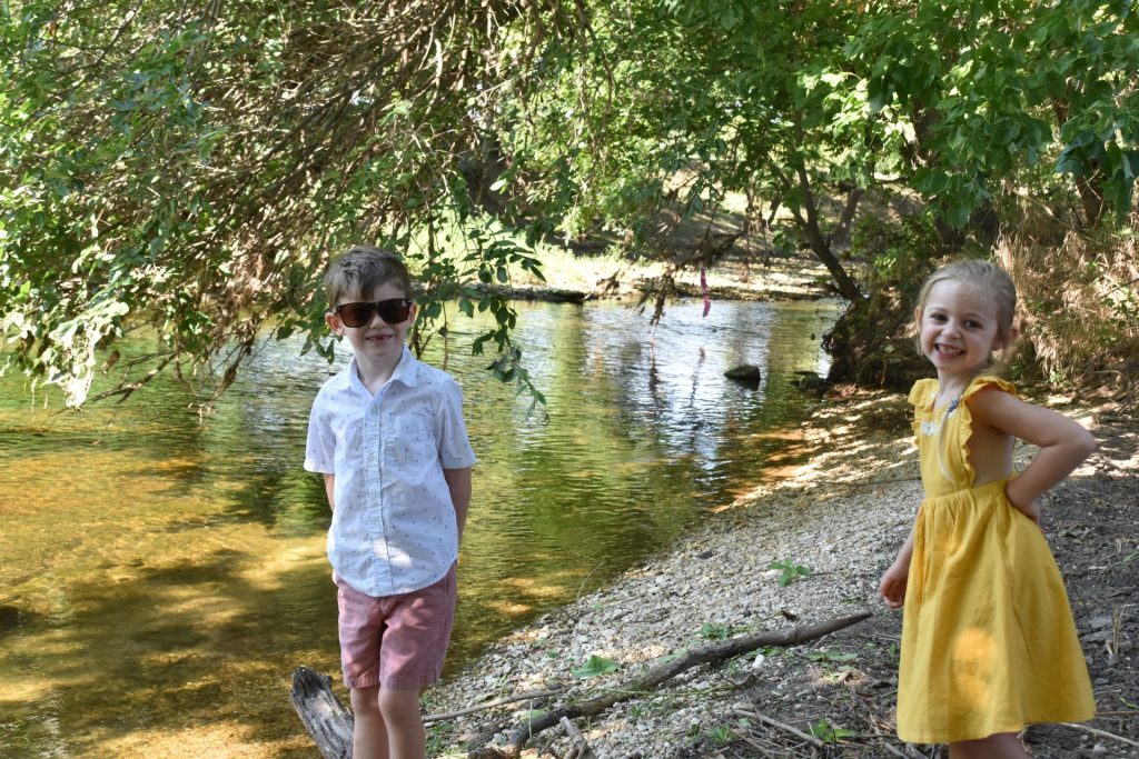 Kids playing by Brushy Creek at Redbud Ranch RV Resort in Hutto, Texas